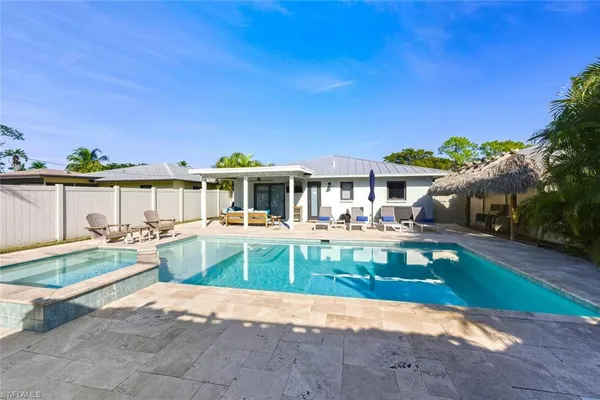 a view of a house with backyard porch and sitting area