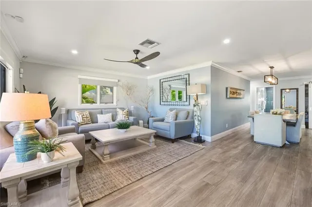 a living room with furniture and wooden floor