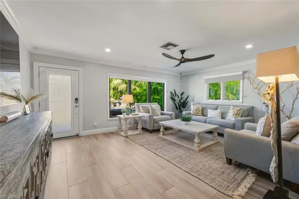 a living room with furniture and a large window