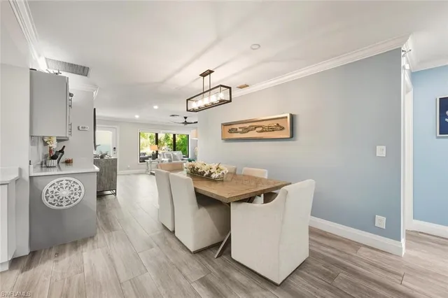 a living room with a table and chairs