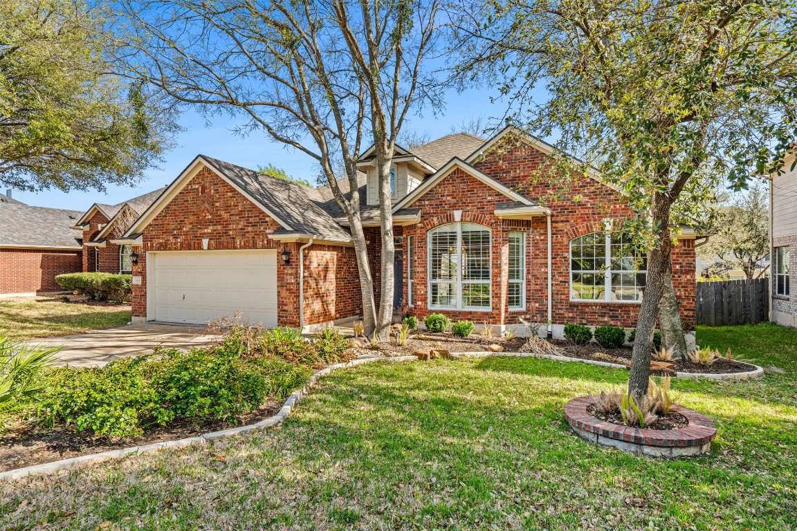 1414 Bull Horn Loop Round Rock, TX 78665 - Photo 1 of 18 a front view of a house with a yard and trees
