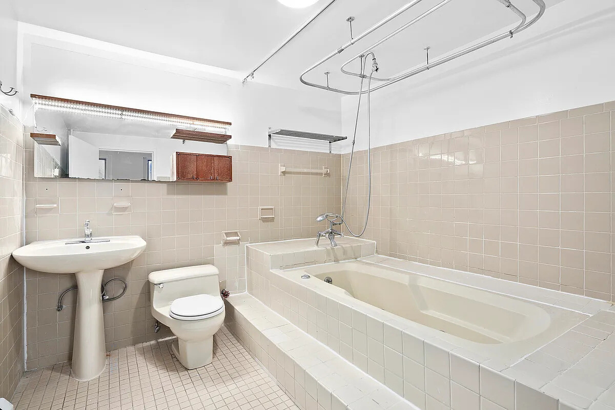 471 Broadway, Unit 3 Manhattan, NY 10013 - Photo 7 of 10 a bathroom with a sink toilet and shower