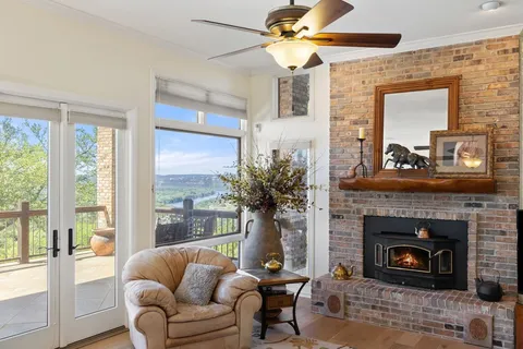 a living room with furniture and large windows