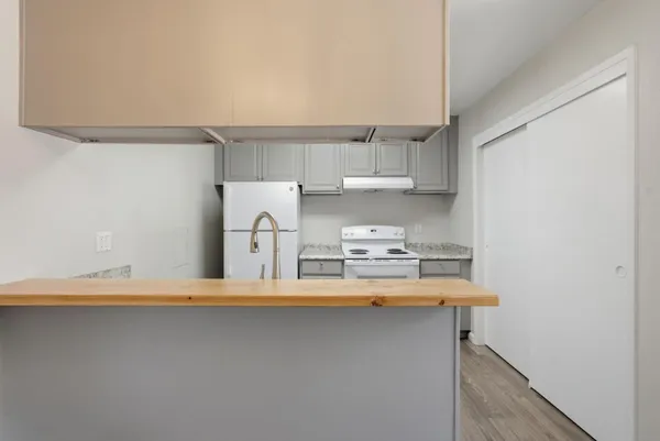 a kitchen with kitchen island a sink stove and refrigerator