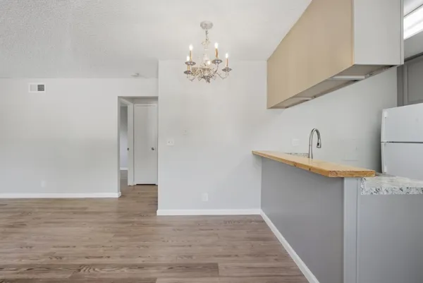 a view of a kitchen with a sink and a chandelier