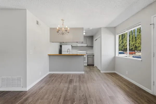 a room with wooden floor and window