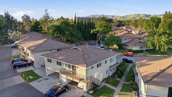 an aerial view of houses with yard