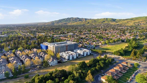 an aerial view of residential houses with city view