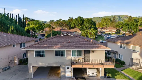 an aerial view of a house with garden space and street view