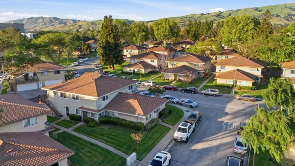 an aerial view of a house with a yard and swimming pool