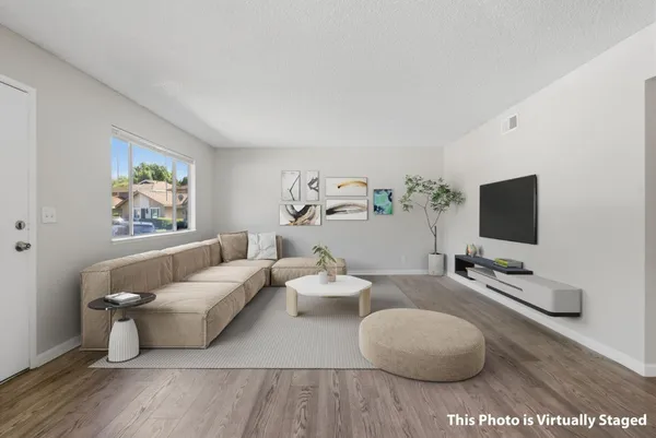 a living room with couches and a flat screen tv