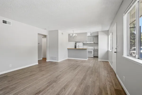 a view of a kitchen with wooden floor and a kitchen