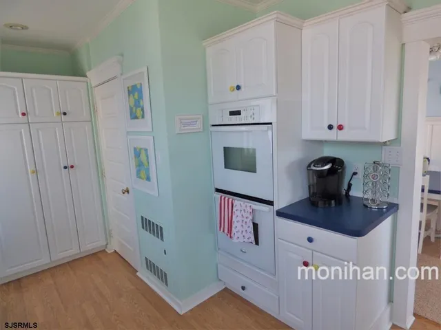 a kitchen with cabinets and window