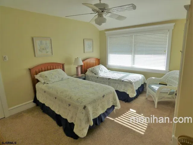 a spacious bedroom with two beds and a table