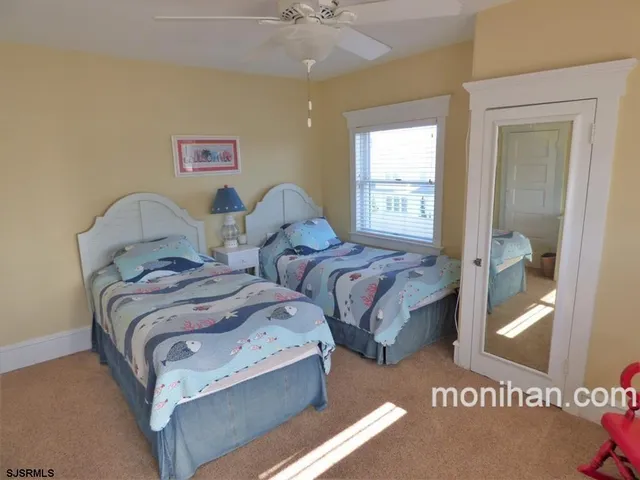 a bedroom with two beds and a table