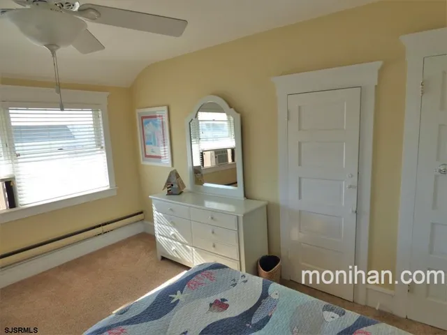 a bathroom with a sink mirror and a shower