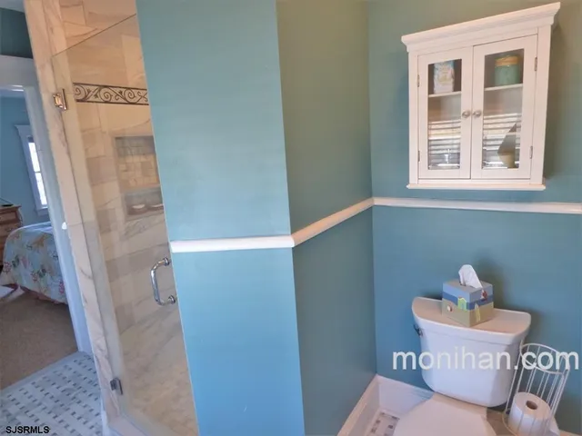 a bathroom with a sink and mirror with toilet