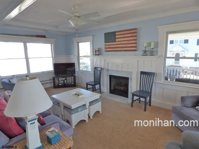 a living room with furniture a fireplace and windows