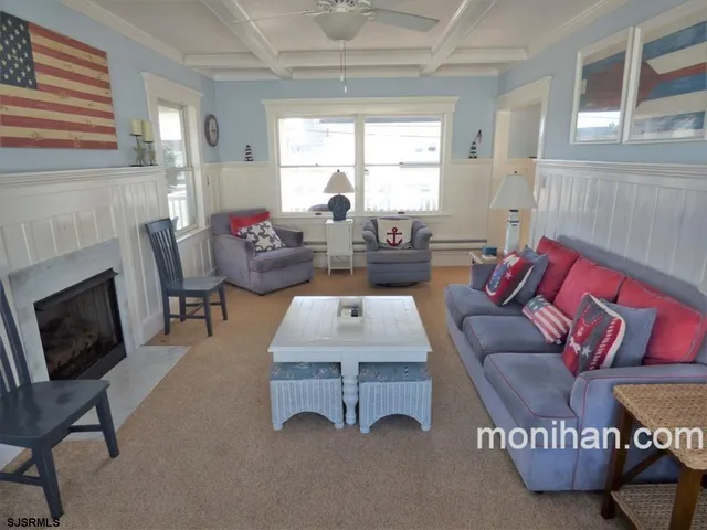 a living room with furniture a fireplace and a table