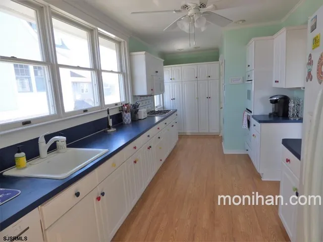 a spacious bathroom with a sink a mirror and a bathtub