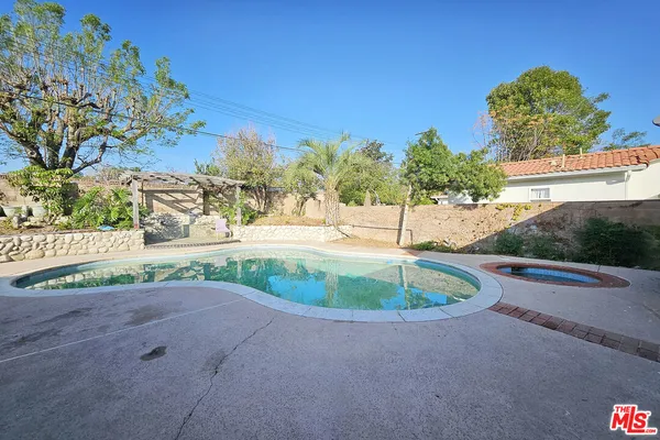 a view of a swimming pool with a patio