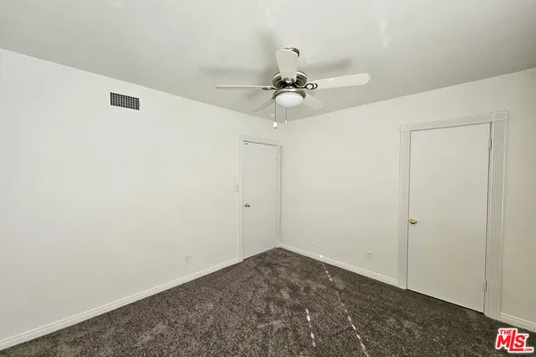 a view of a livingroom with a ceiling fan and window