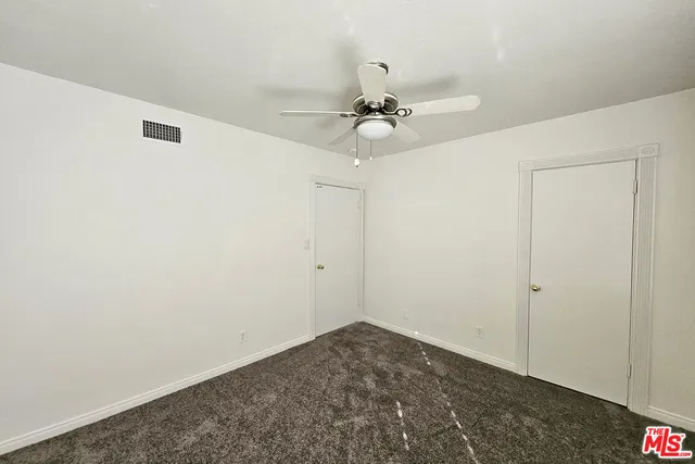 a view of a livingroom with a ceiling fan and window