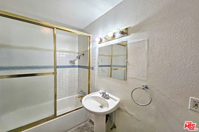 a bathroom with a sink toilet and a mirror