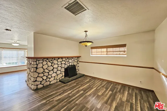a view of a room with wooden floor and windows