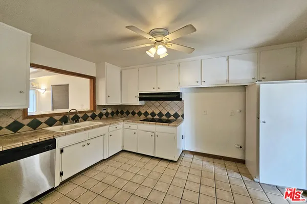 a kitchen with a stove a sink and a refrigerator