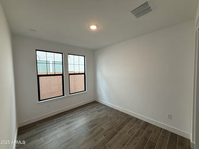 a view of staircase with wooden floor and white walls