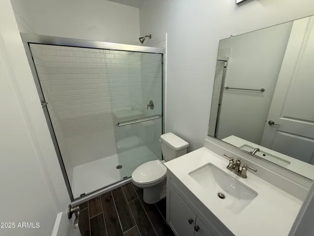 an empty room with wooden floor and sliding door