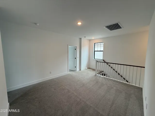 an empty room with windows and entrance