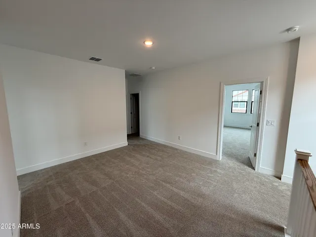 a view of an empty room and a window