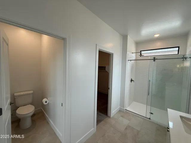 a bathroom with a double vanity sink mirror double shower and a bathtub