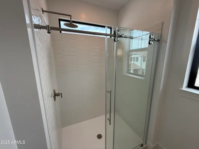 a bathroom with a granite countertop toilet and a shower