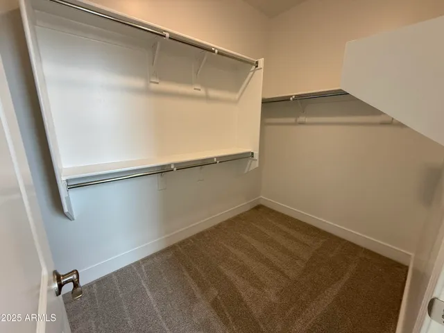 a bathroom with a double vanity sink toilet and mirror