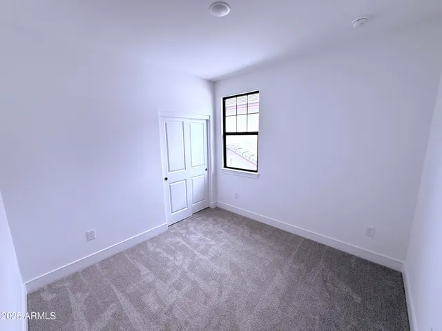 a bathroom with a sink vanity mirror and toilet