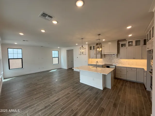 a view of a kitchen with wooden floor
