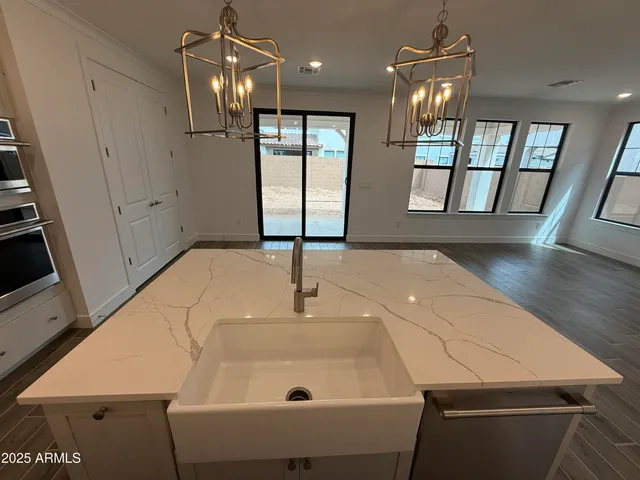 a kitchen with granite countertop white cabinets and stainless steel appliances
