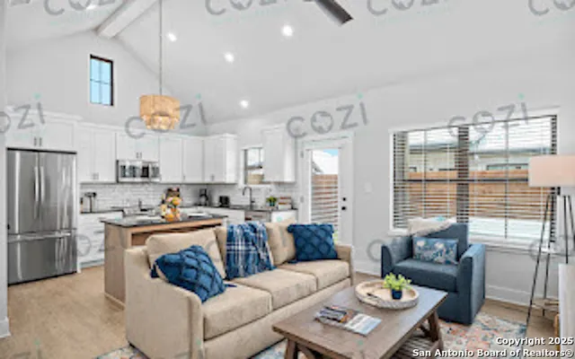 a living room with furniture wooden floor and a chandelier