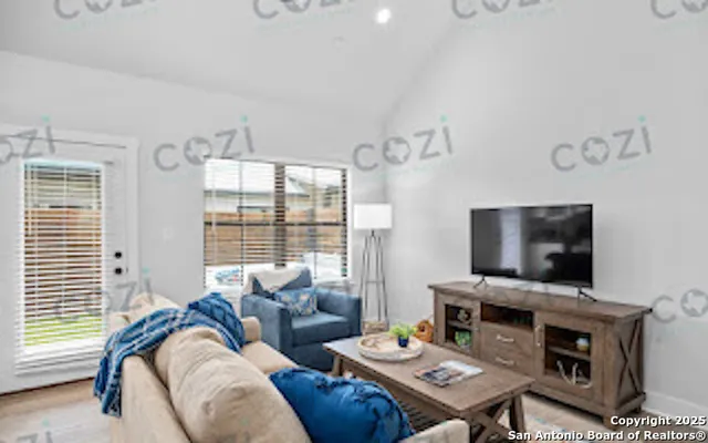 a living room with furniture and a flat screen tv