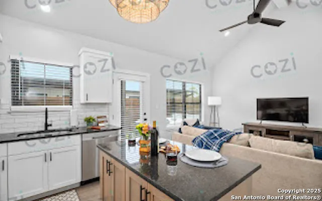 a kitchen with a sink and a stove top oven