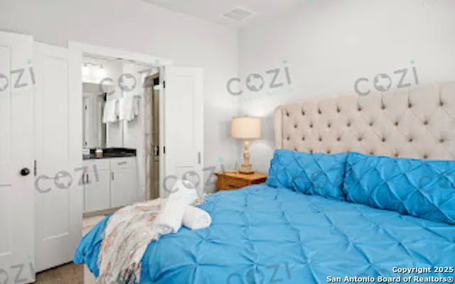 a bedroom with a bed and a view of bathroom