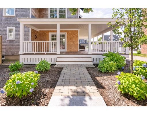 16 Gannett Road Scituate, MA 02066 - Photo 11 of 42 a view of a house with a small yard and flower plants