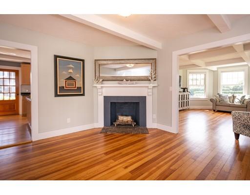 16 Gannett Road Scituate, MA 02066 - Photo 17 of 42 a view of a livingroom with wooden floor and a fireplace