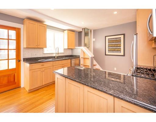 16 Gannett Road Scituate, MA 02066 - Photo 21 of 42 a kitchen with stainless steel appliances granite countertop a sink and cabinets with wooden floor