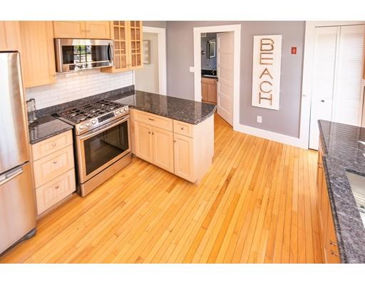16 Gannett Road Scituate, MA 02066 - Photo 22 of 42 a kitchen with granite countertop a stove and cabinets