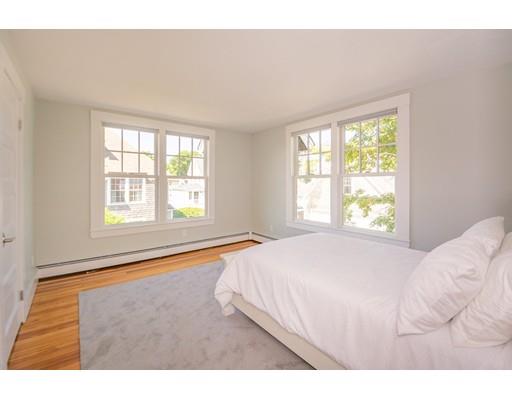 16 Gannett Road Scituate, MA 02066 - Photo 28 of 42 a bedroom with a bed and a large window