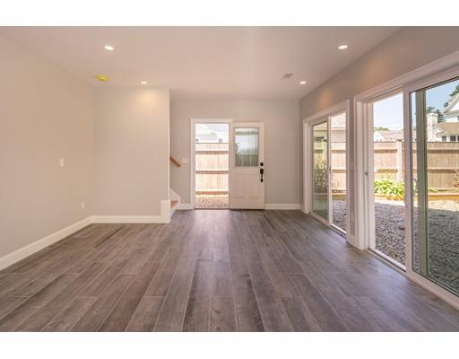 16 Gannett Road Scituate, MA 02066 - Photo 32 of 42 a view of an empty room with wooden floor and a window